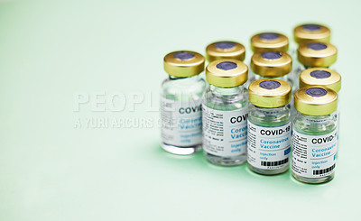 Buy stock photo Studio shot of vaccine tubes against a green background