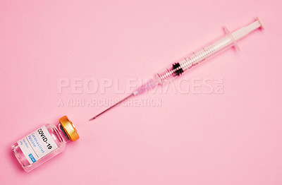 Buy stock photo Studio shot of a vaccine tube and syringe against a pink background