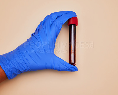 Buy stock photo Shot of an unrecognizable person holding vaccine tubes  against an orange background