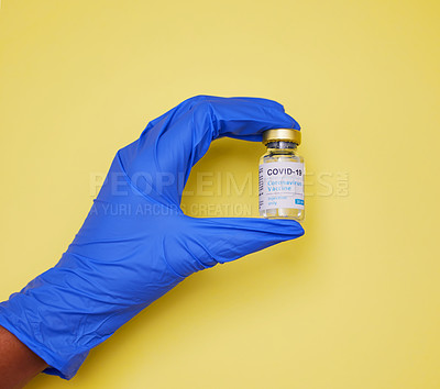 Buy stock photo Shot of an unrecognizable person holding vaccine tubes  against a yellow background