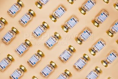 Buy stock photo Studio shot of vaccine tubes against an orange background