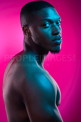 Buy stock photo Studio shot of a fit young man posing against a pink background