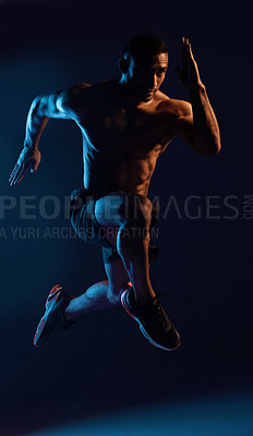 Buy stock photo Studio shot of a handsome young man working out against a dark background