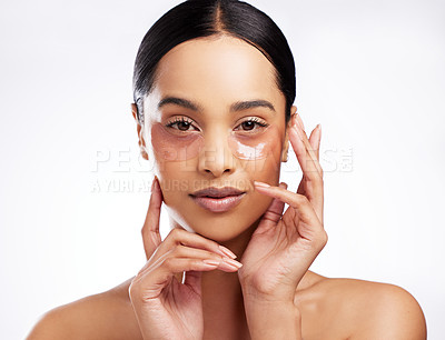 Buy stock photo Studio portrait of a beautiful young woman wearing under-eye patches against a white background