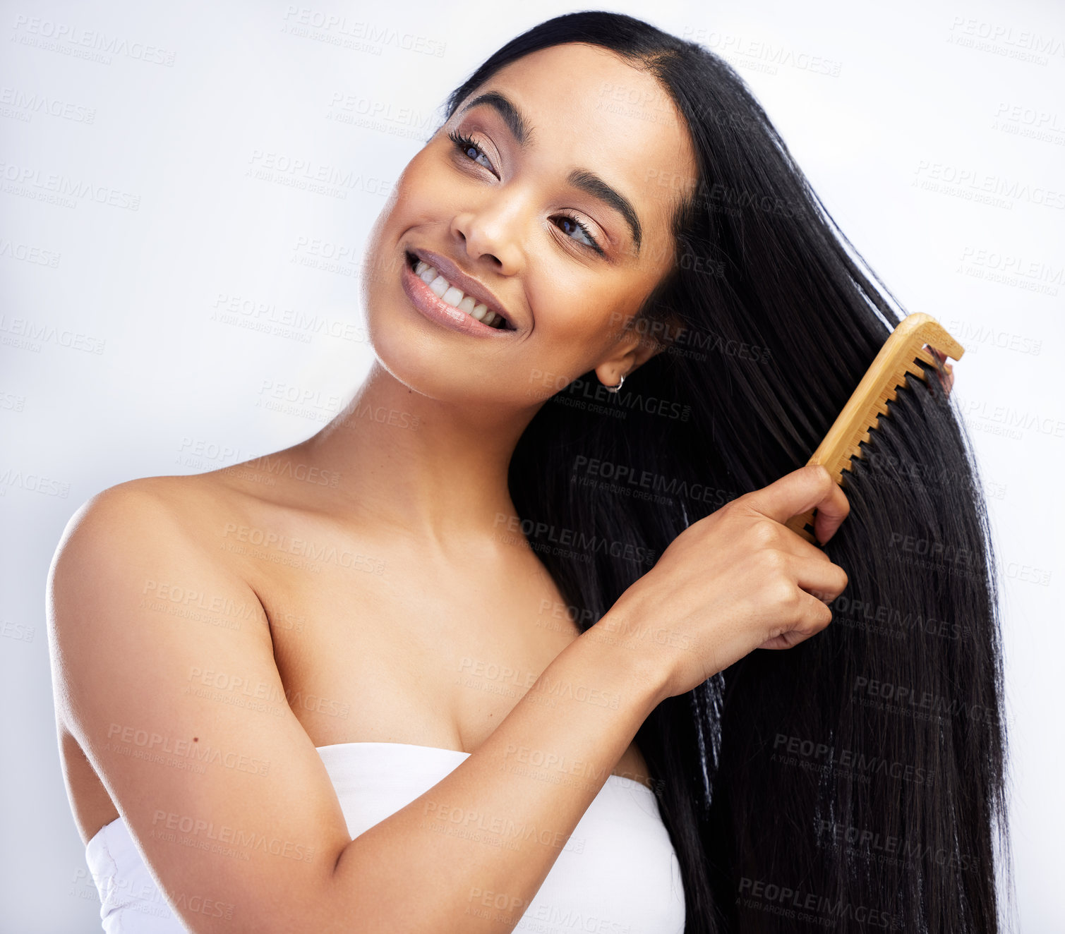 Buy stock photo Hair care, smile and woman with comb in studio for salon aesthetic and healthy scalp for growth. Model girl, keratin texture and beauty tool with sustainable wood for detangling by white background