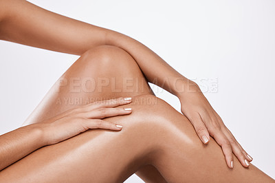 Buy stock photo Studio shot of an unrecognisable woman touching her legs against a white background