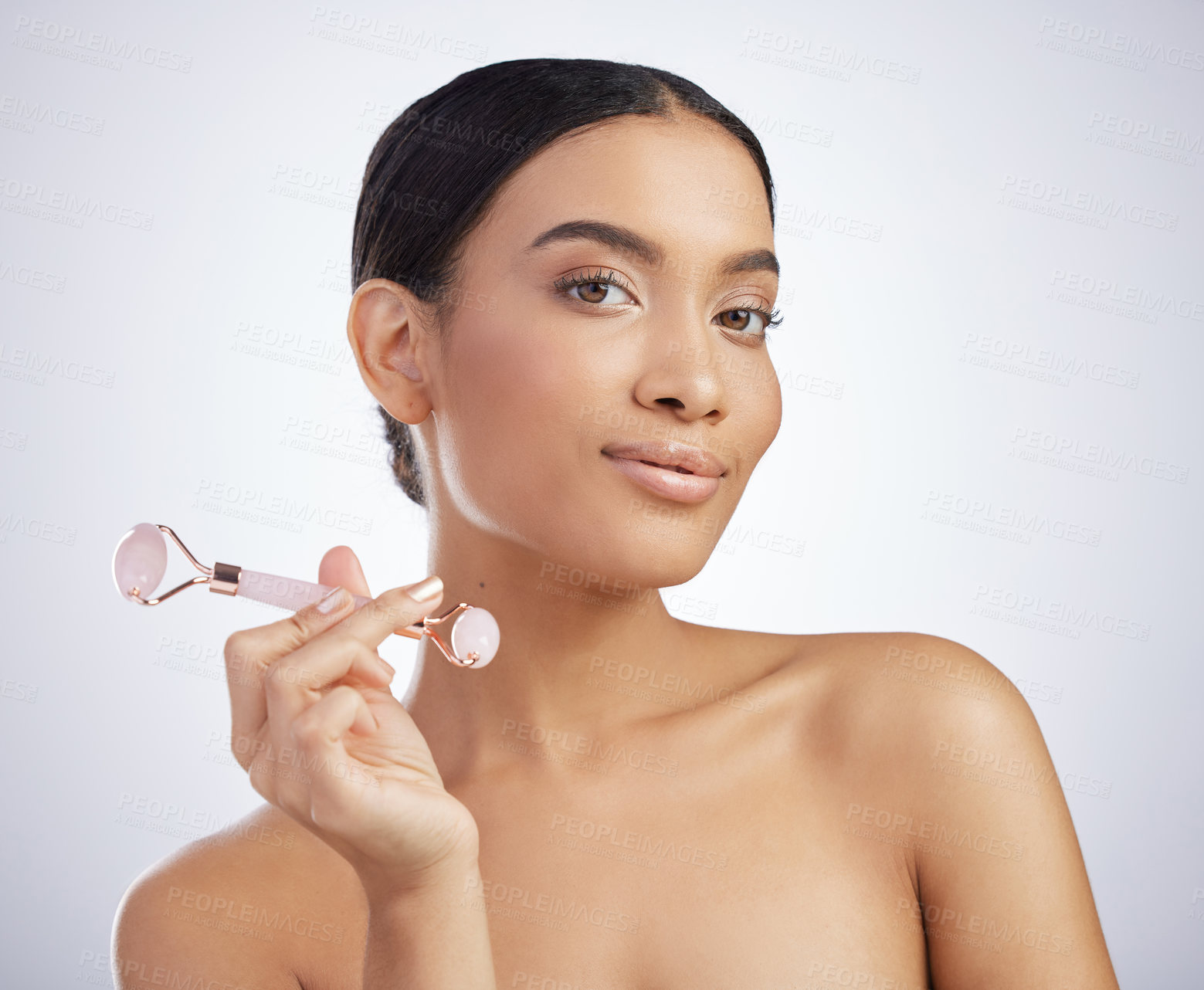 Buy stock photo Skincare, portrait or derma roller by Mexican girl in studio for facelift, cosmetics and anti aging on white background. Rose quartz, crystal or model with stone facial, lymphatic drainage or massage