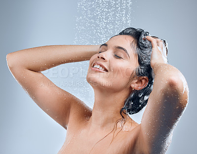 Buy stock photo Water, shower and woman for hair care with hygiene, shine results and clean scalp for growth in studio. Liquid drops, model girl and shampoo wash for texture and cleaning routine by grey background