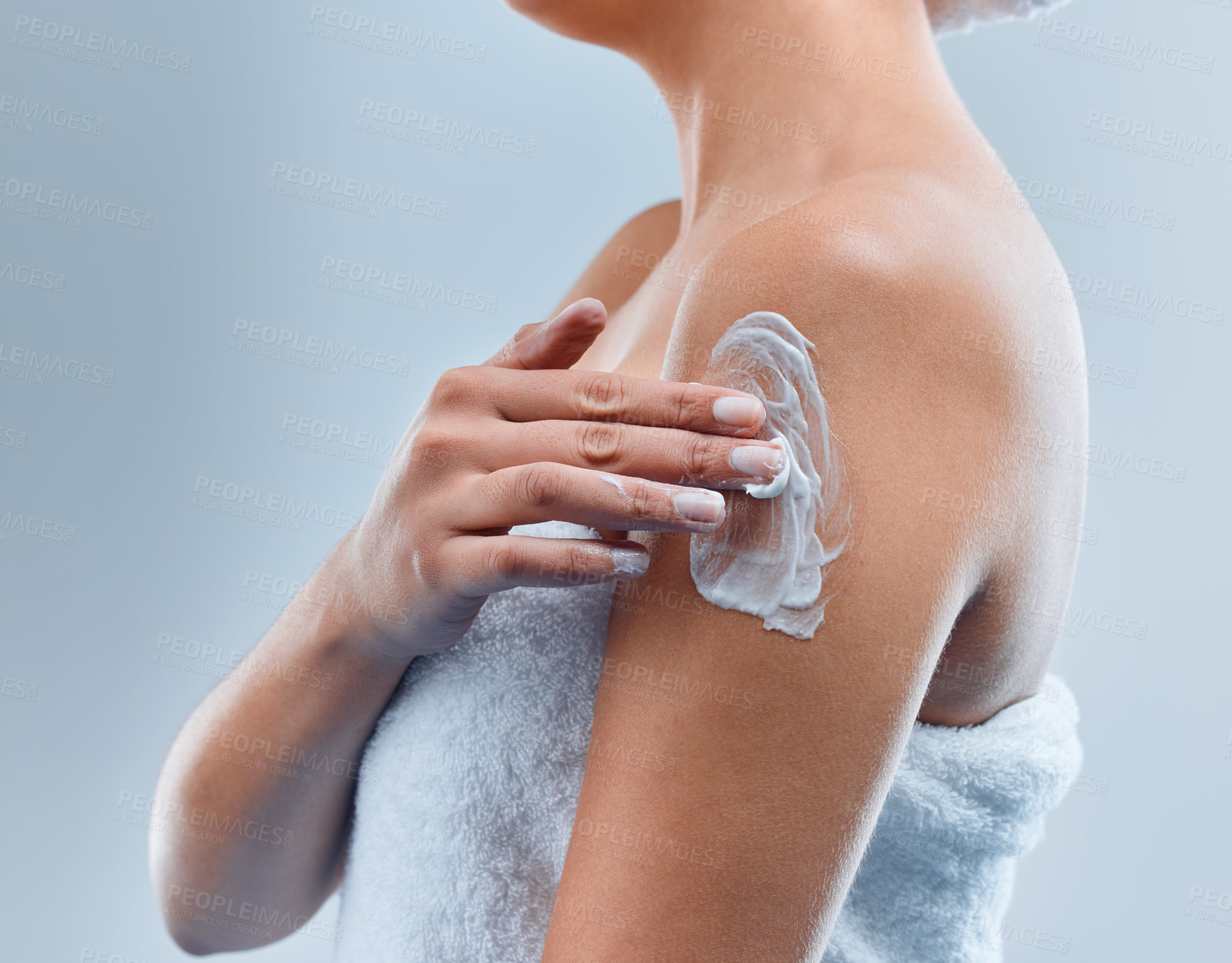 Buy stock photo Shot of an unrecognizable person applying cream in the shower against a grey background