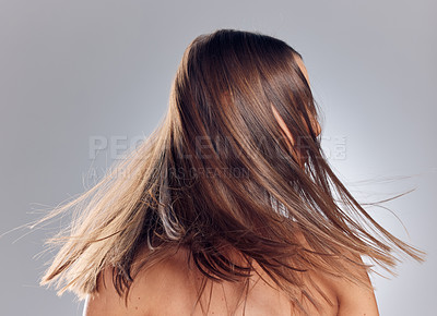 Buy stock photo Shot of an unrecognizable woman standing alone in the studio and shaking her hair