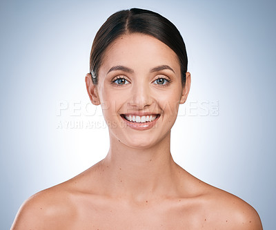Buy stock photo Portrait of a beautiful young woman posing against a blue background
