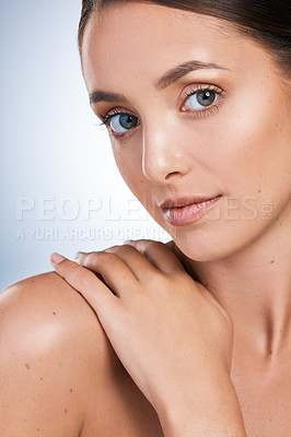 Buy stock photo Closeup portrait of a beautiful young woman posing against a blue background