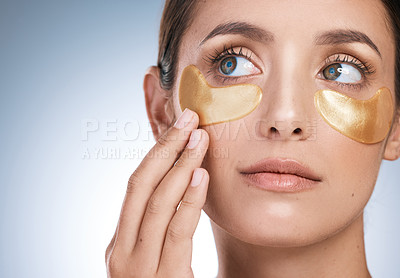 Buy stock photo Cropped shot of a young attractive woman wearing an under eye patch against a blue background