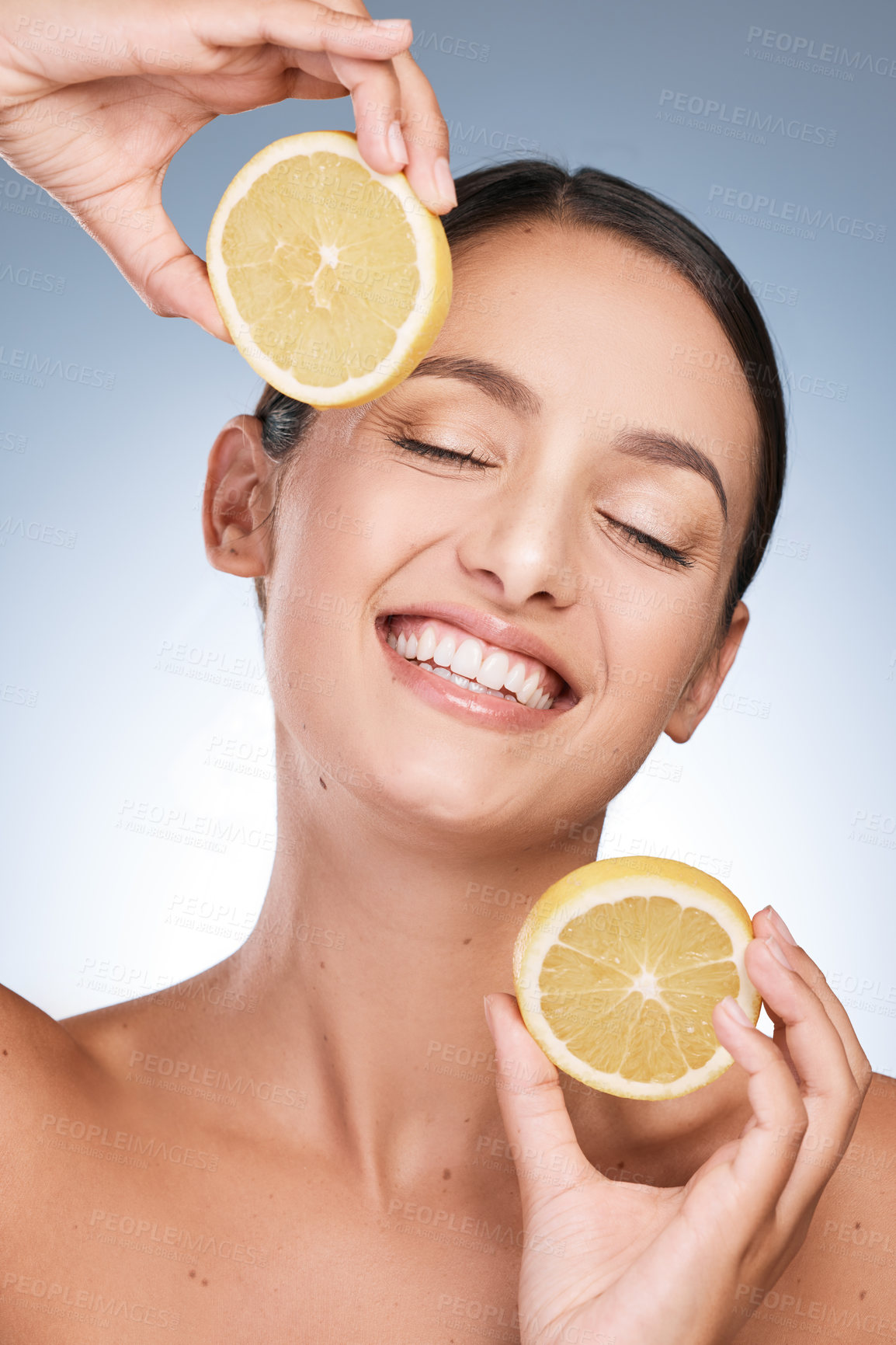 Buy stock photo Happy woman, skincare and eyes closed with orange slices in studio backdrop, satisfied by results in blue background. Female person, face and organic for cosmetic, pride or glow for dermatology