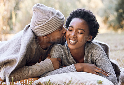 Buy stock photo Shot of a young man kissing his girlfriend during a camping trip