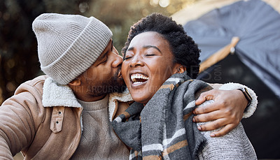 Buy stock photo Camping, laugh and couple in nature kiss on holiday, vacation and adventure on weekend together. Relax, dating and black man and woman outdoors for bonding, loving relationship and sitting by tent