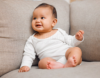 Buy stock photo Shot of an adorable baby girl sitting on the couch at home