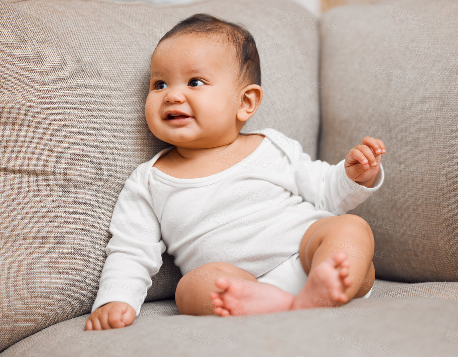 Buy stock photo Shot of an adorable baby girl sitting on the couch at home