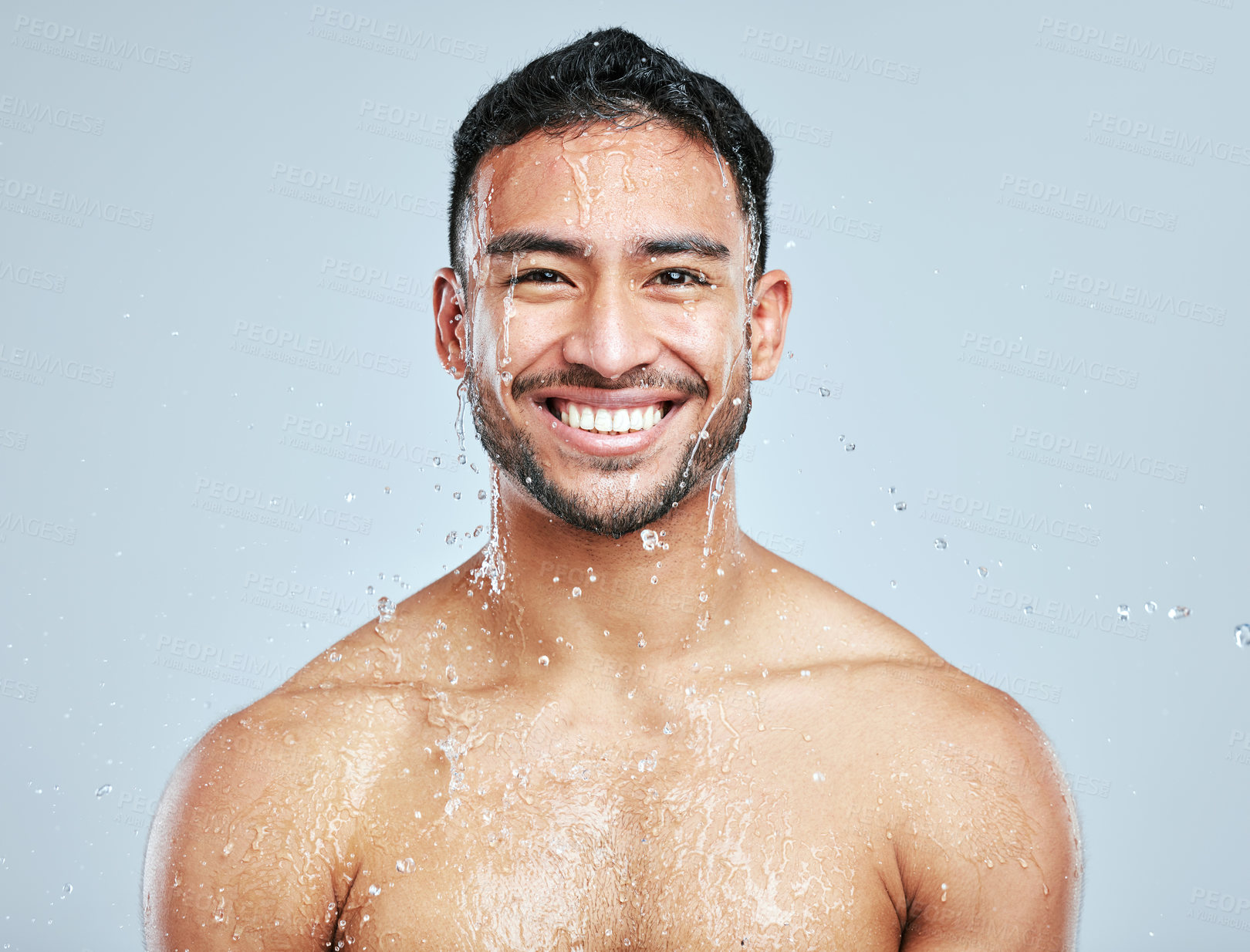 Buy stock photo Man, shower and water on body for cleaning, skincare and wash on white studio background with smile. Male person, portrait and hygiene with clear liquid for facial, wellness and self care in bathroom