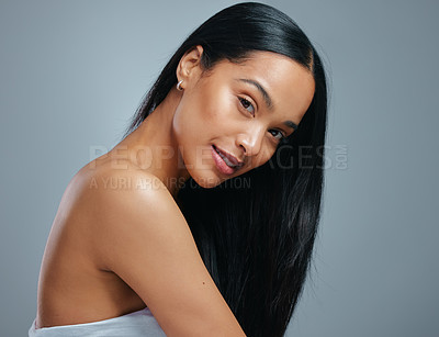 Buy stock photo Studio portrait of an attractive young woman posing against a grey background