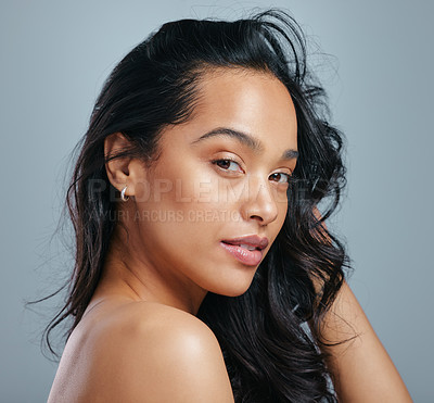 Buy stock photo Studio portrait of an attractive young woman posing against a grey background