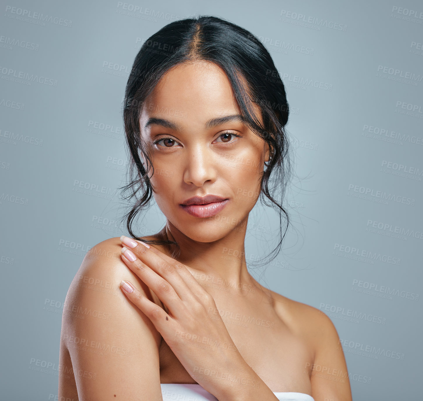 Buy stock photo Studio portrait of an attractive young woman posing against a grey background