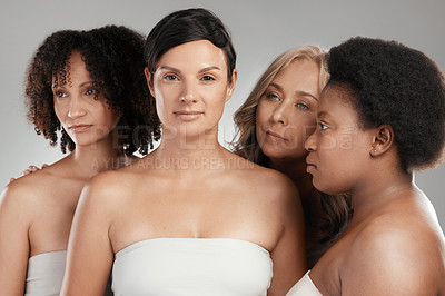 Buy stock photo Shot of a diverse group of women standing close together in the studio and posing