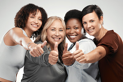 Buy stock photo Shot of a diverse group of women standing together in the studio and showing a thumbs up