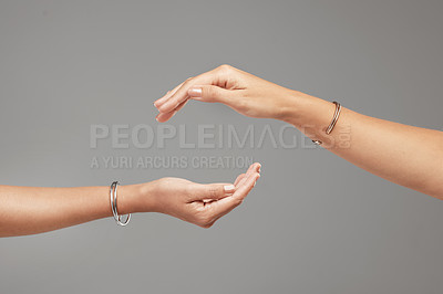Buy stock photo Cropped shot of two unrecognizable women posing with their hands cupped above each other