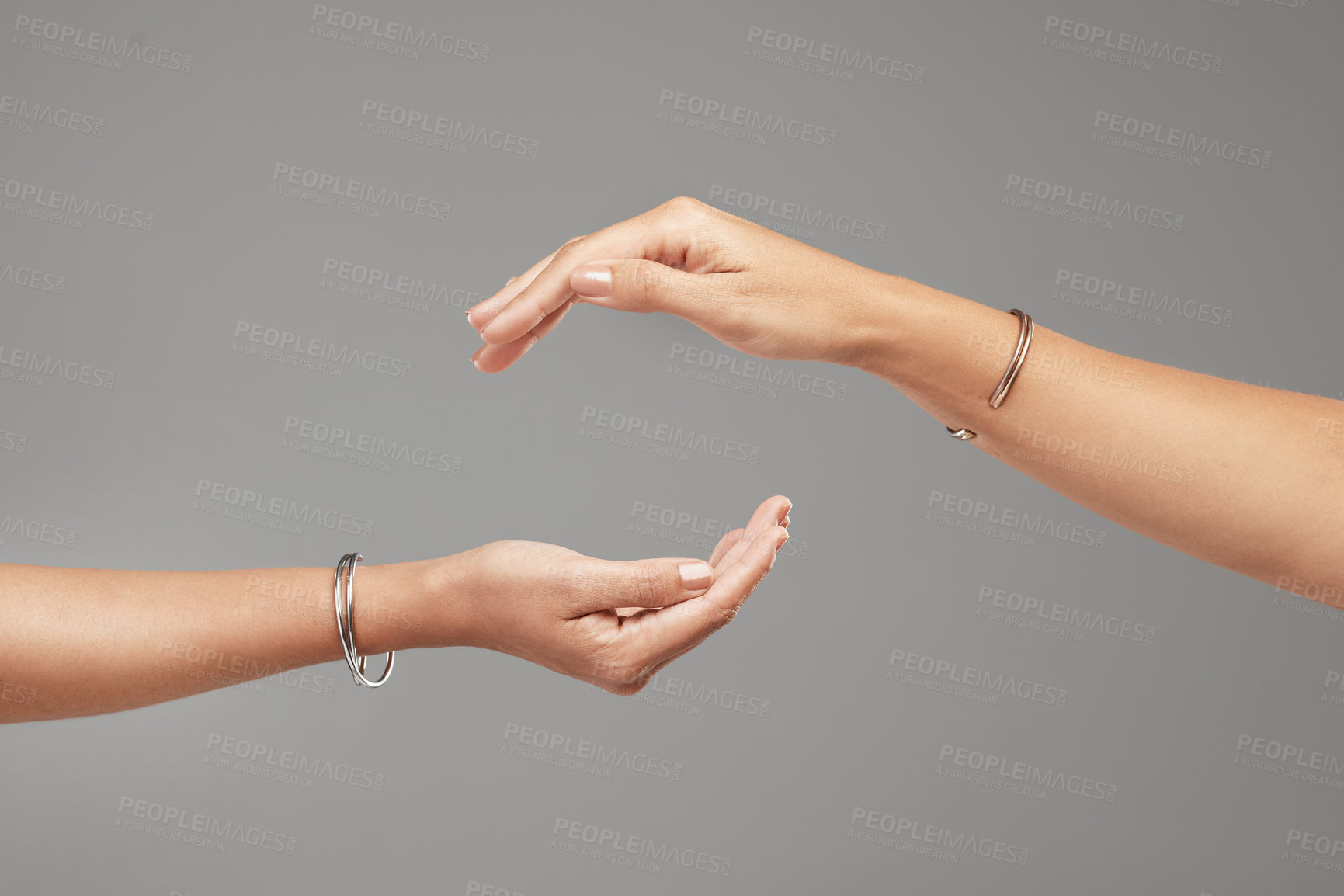 Buy stock photo Cropped shot of two unrecognizable women posing with their hands cupped above each other