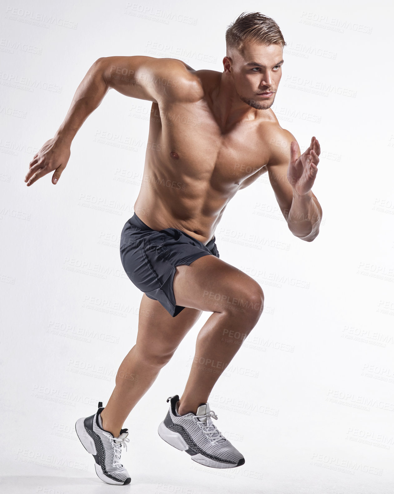 Buy stock photo Shot of an athletic young man posing against a white background