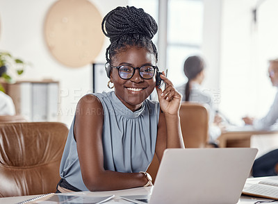 Buy stock photo Shot of a young woman using a headset and laptop in a modern office