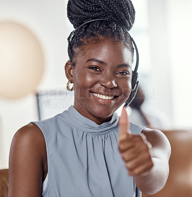 Buy stock photo Shot of a young woman using a headset and showing thumbs up in a modern office