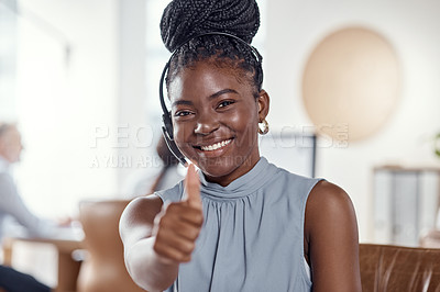 Buy stock photo Shot of a young woman using a headset and showing thumbs up in a modern office