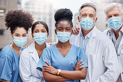 Buy stock photo Shot of a group of doctors standing in the city