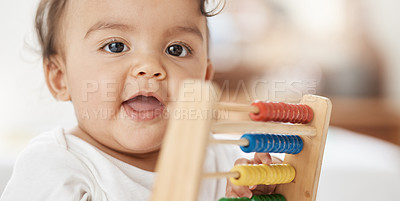 Buy stock photo Shot of an adorable baby girl playing with a wooden abacus