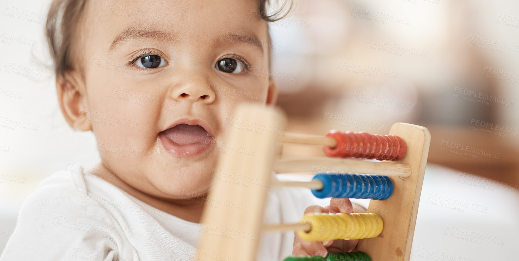 Buy stock photo Shot of an adorable baby girl playing with a wooden abacus