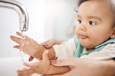 Buy stock photo Cropped shot of a woman washing her baby's hands