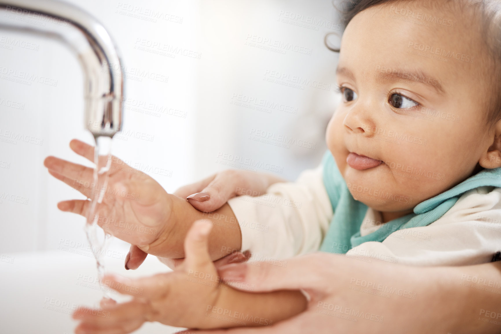 Buy stock photo Cropped shot of a woman washing her baby's hands