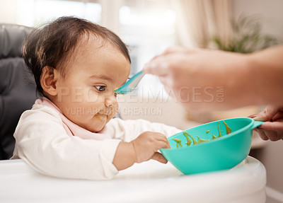 Buy stock photo Shot of an adorable baby girl eating her food