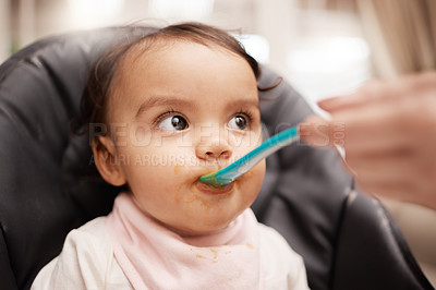 Buy stock photo Shot of an adorable baby girl eating her food