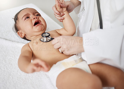 Buy stock photo Shot of a paediatrician using a stethoscope during a baby's checkup
