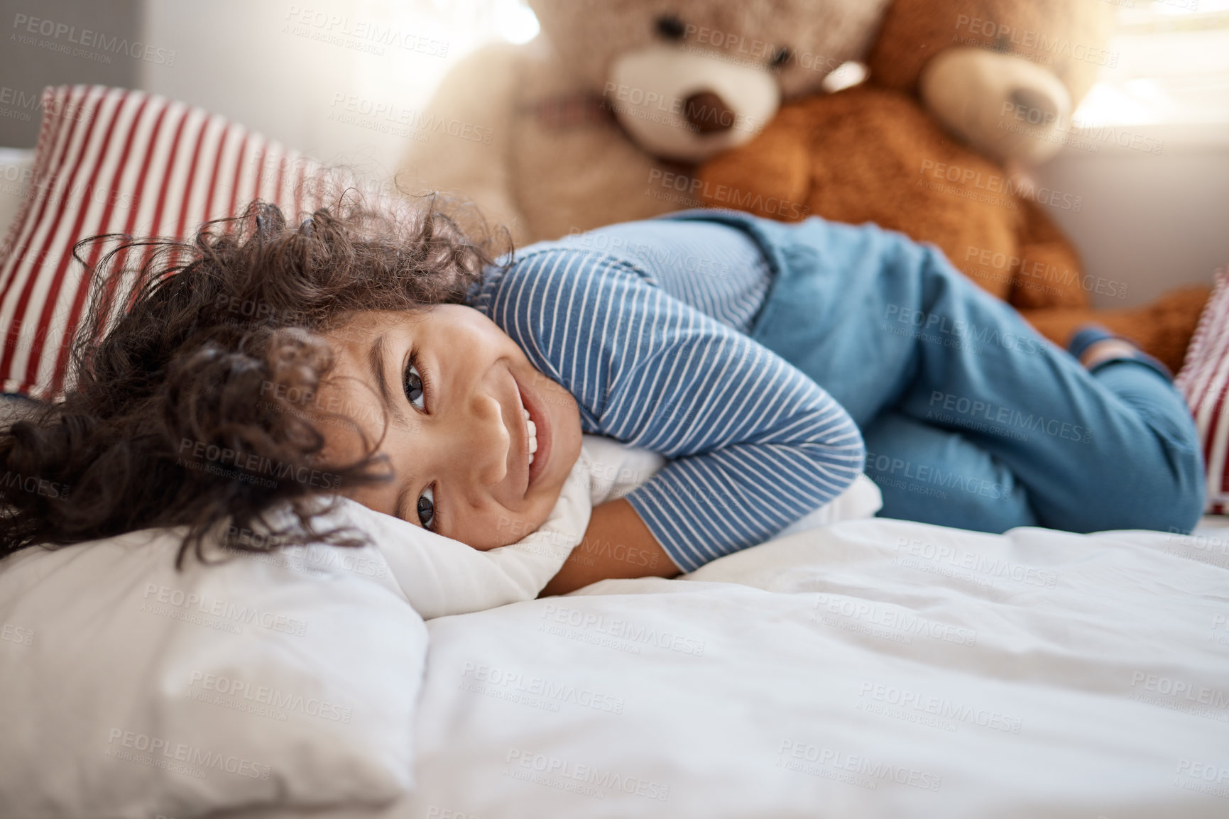 Buy stock photo Portrait of an adorable young boy relaxing on his bed at home