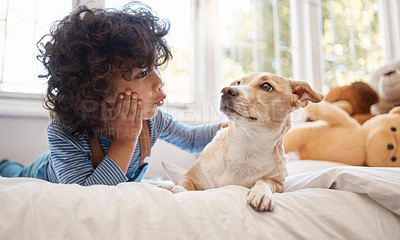 Buy stock photo Shot of an adorable young boy playing with his dog in his bedroom at home