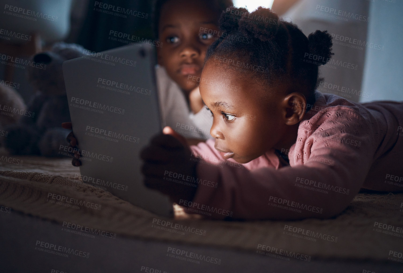 Buy stock photo Shot of siblings using their digital tablet together