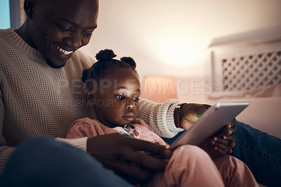 Buy stock photo Shot of a father reading his daughter bedtime stories