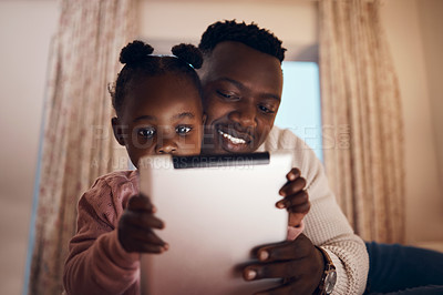 Buy stock photo Shot of a father reading his daughter bedtime stories