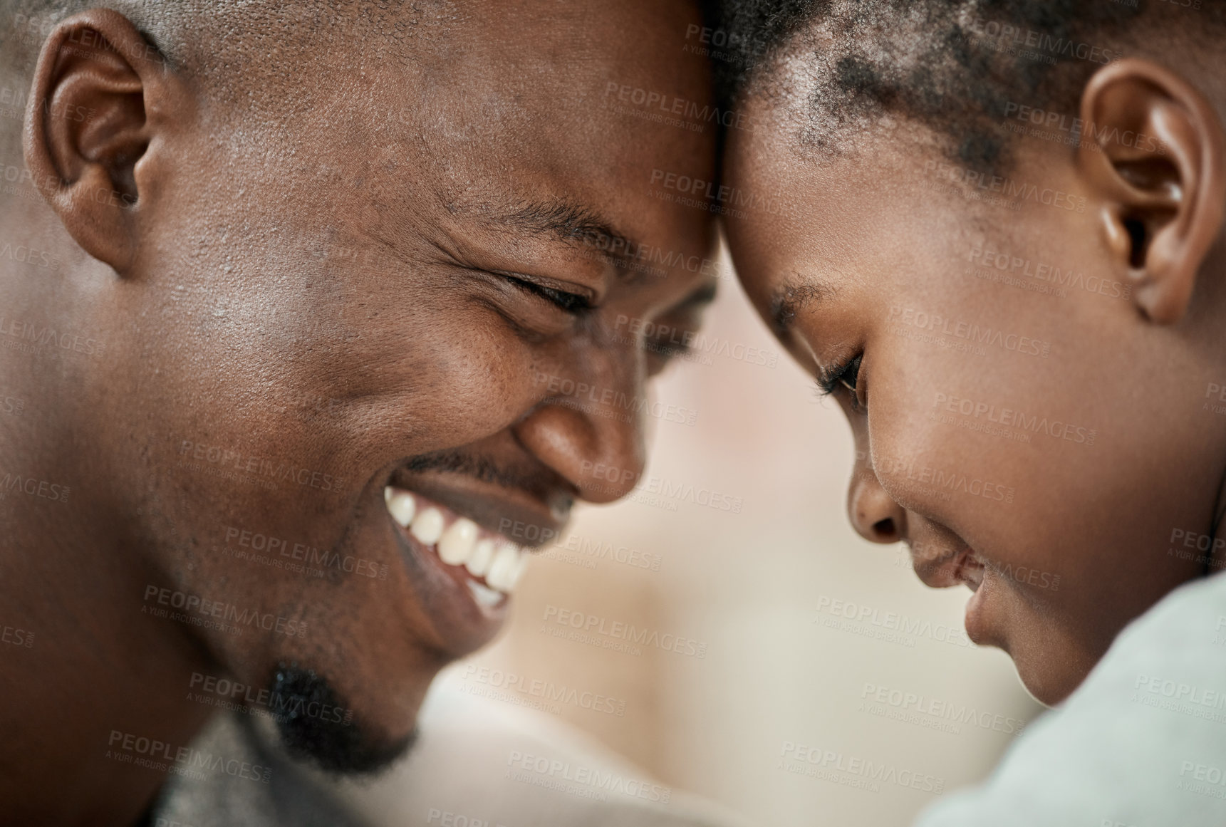 Buy stock photo Cropped shot of a handsome young man and his son standing face to face with their heads touching in the living room at home