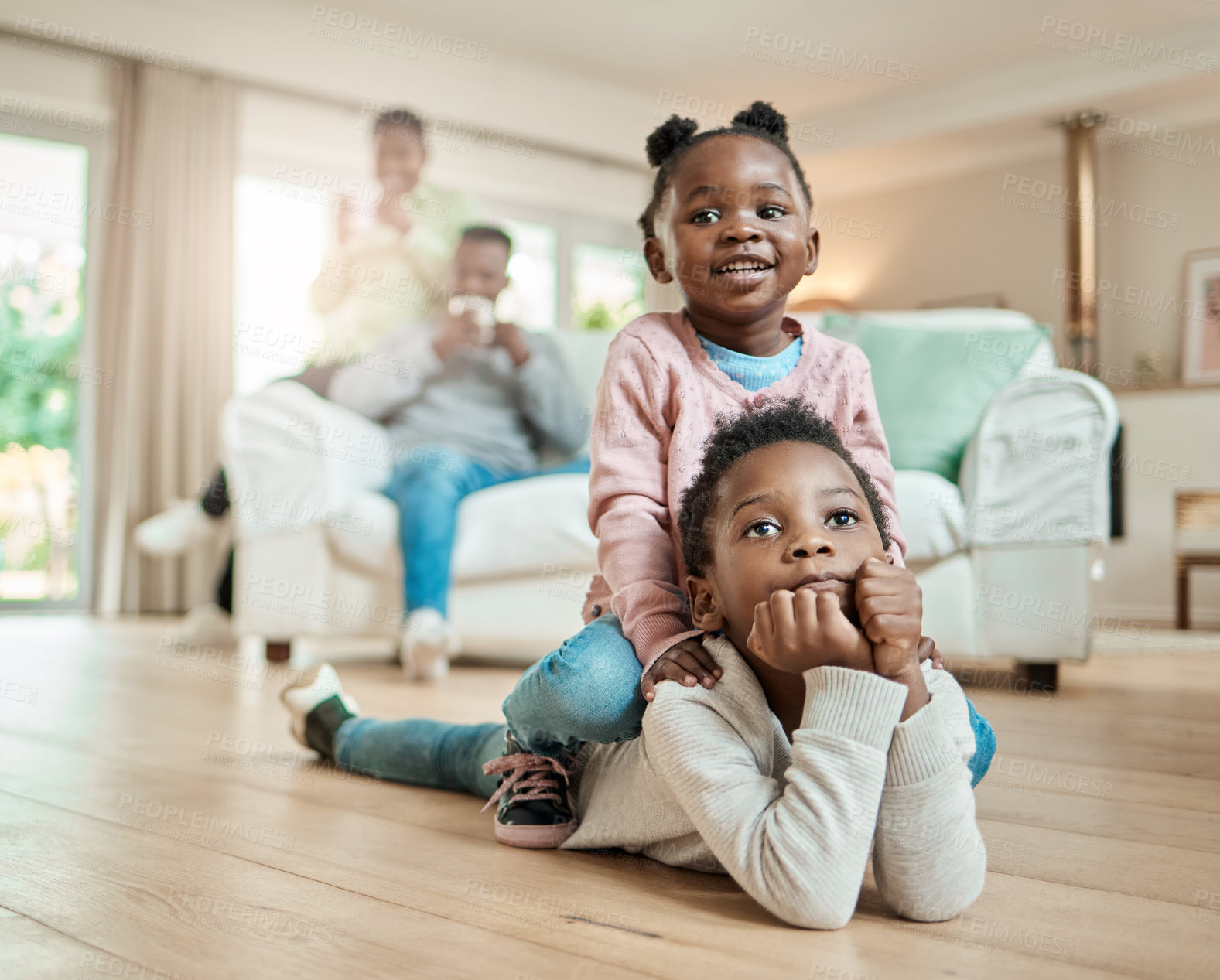 Buy stock photo Black family, home and siblings on floor, relax and bonding together for fun, happiness and playing. Apartment, African parents and sister on brother, games and entertainment with smile and calm