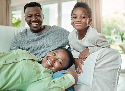 Buy stock photo Cropped portrait of an affectionate young family of three relaxing on the sofa in their living room at home